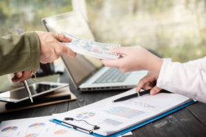 Scott-Lippitt business man giving money showing contract